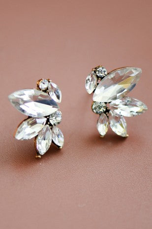 A pair of small clear crystal stud earrings with a floral design.