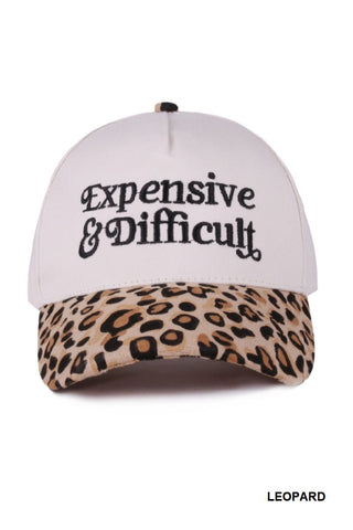 White cap with leopard print brim and 'Expensive & Difficult' text on a white background