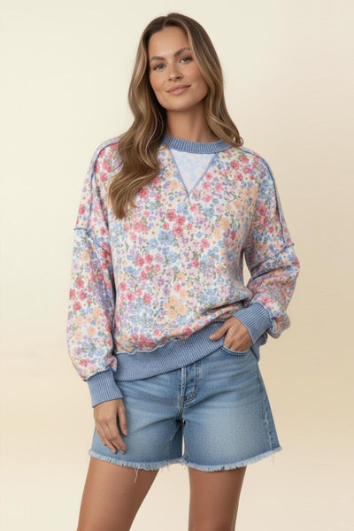 light weight long sleeve T-shirt like a sweatshirt with pale blue trim and pastel florals and drop shoulders