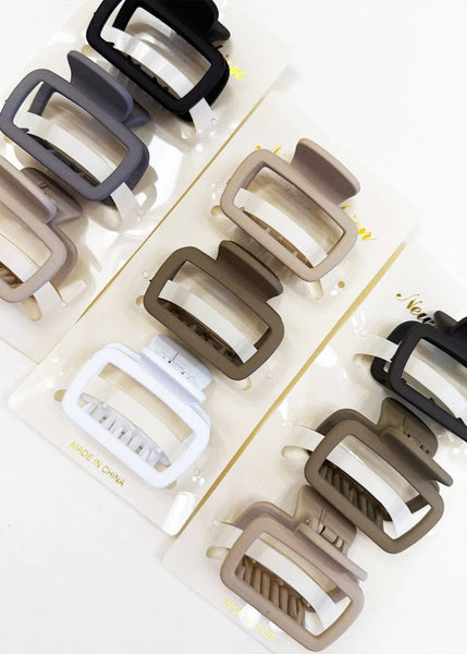 Set of various hair clips in different colors on a white background