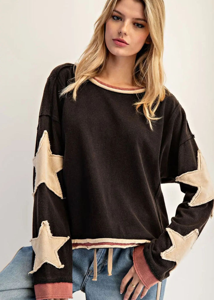 Long sleeved ash black base, with cream color star accents on sleeves
