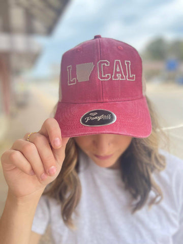 Minnesota local ponytail baseball cap.  pinkish red with Minnesota state emblem as the 'O' in Local