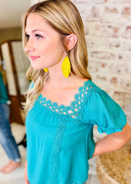 Woman wearing Teal Shirt with a Square Neck Line and Scalloped Lace 